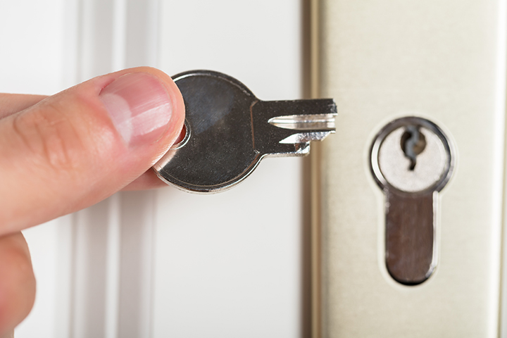 a close up of a key that has broken in the lock in front of the door