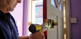 steve the locksmith about to replace a door lock on a new house for a first time buyer