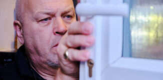 Steve the locksmith inspecting a door for signs of what is lock bumping