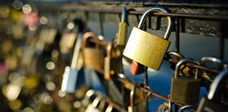 different types of padlocks attached to a bridge